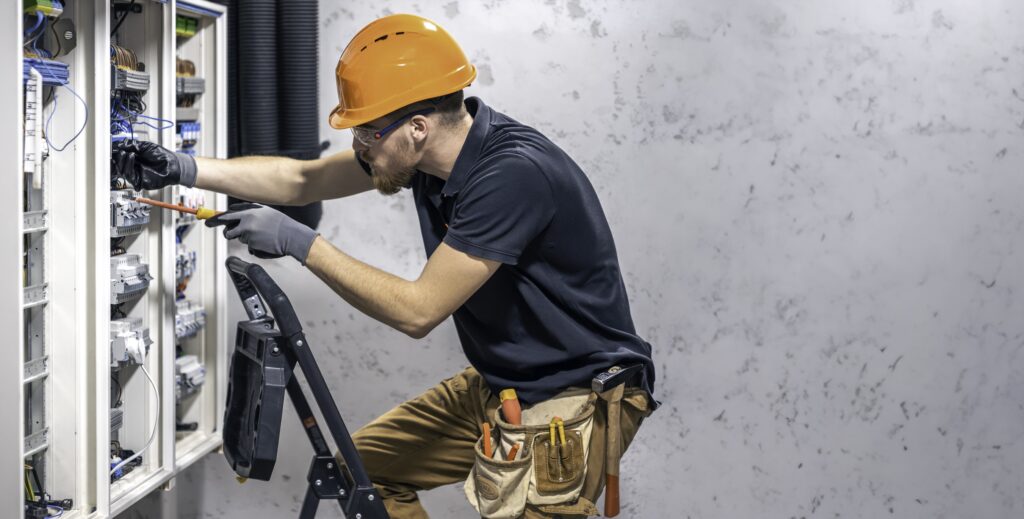 electrician-working-switchboard-with-electrical-connection-cable-copy-space-min